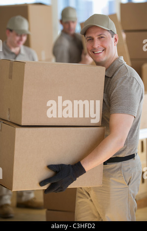 Men sorting boxes in warehouse Stock Photo