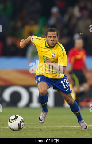 Dani Alves of Brazil drives the ball during a FIFA World Cup Group G soccer match against Cote d'ivoire June 20, 2010. Stock Photo