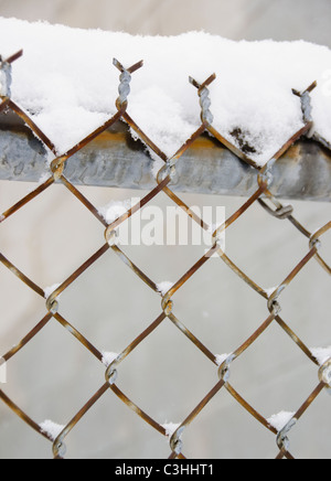 Snow covered chainlink fence Stock Photo