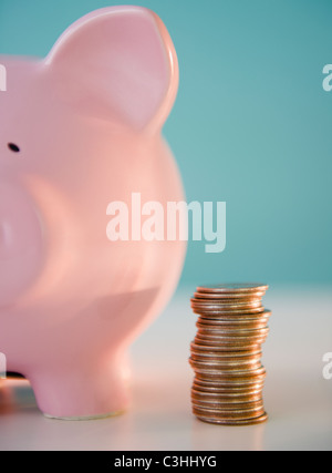 Close-up of Coins stack and piggy bank Stock Photo - Alamy