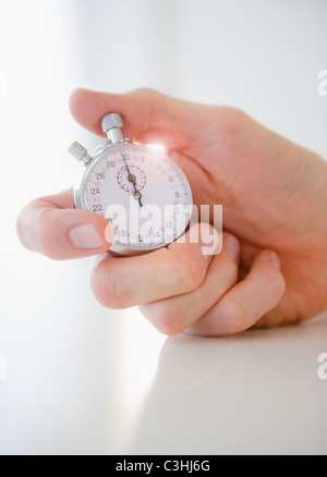 Hand holding stopwatch Stock Photo