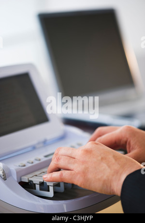 Court stenographer using stenograph machine Stock Photo - Alamy