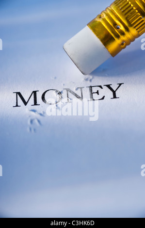 Studio shot of pencil erasing the word money from piece of paper Stock Photo