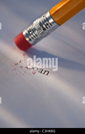 Studio shot of pencil erasing the word loan from piece of paper Stock Photo