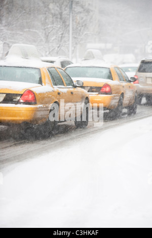 USA, New York City, yellow cabs on snowy street Stock Photo