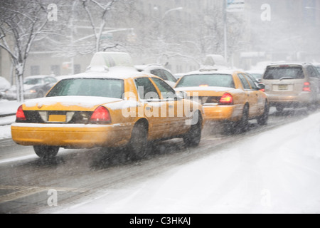 USA, New York City, yellow cabs on snowy street Stock Photo