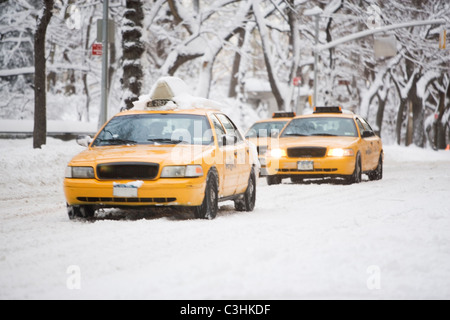 USA, New York City, yellow cabs on snowy street Stock Photo