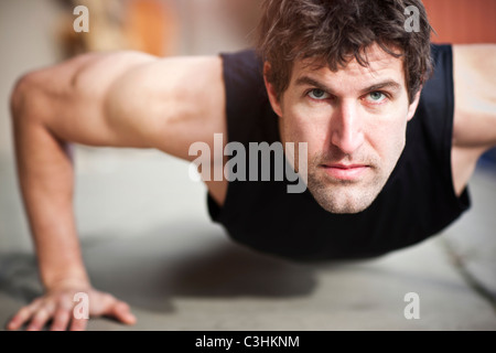 Portrait of man doing push-ups Stock Photo