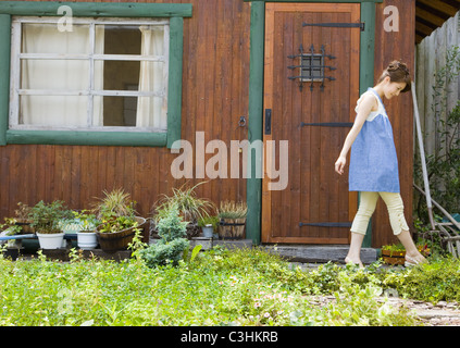 Young woman walking in garden Stock Photo