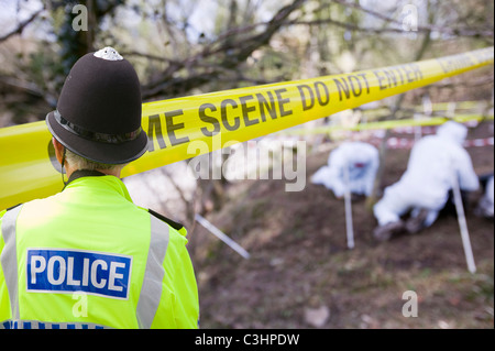 police scenes of crime officers investigate a murder scene on the banks of the river Kent near Kendal Stock Photo