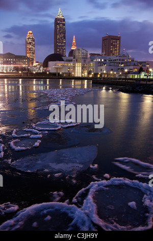 USA, Ohio, Cleveland skyline across frozen lake at sunrise Stock Photo