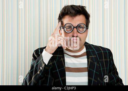 crazy nerd man myopic thinking gesture expression funny glasses man Stock Photo