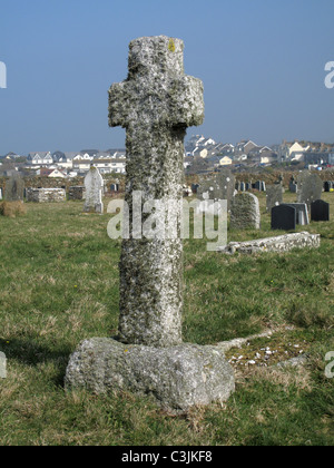 Lichen covered granite stoner cross in a churchyard, Tintagel, Cornwall, March Stock Photo