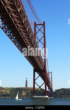 The 25 April Bridge (Ponte 25 de Abril) spans the River Tagus (Rio Tejo) in Lisbon, Portugal. Stock Photo