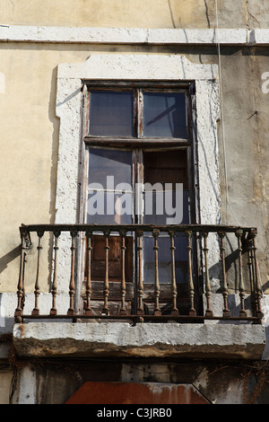 A balcony and broken window in the Alfama district of Lisbon, Portugal. Stock Photo