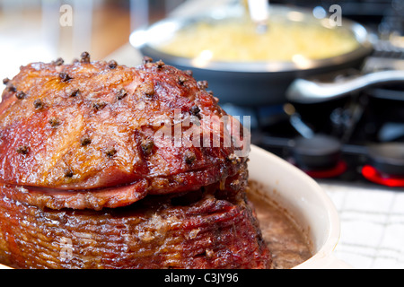 Glazed Spiral Cut Hickory Smoked Ham on Cooking Stove Top Stock Photo