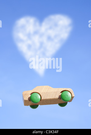 Heart shaped cloud and wooden hot wheels Stock Photo
