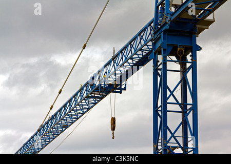 Tower crane arm against a cloudy sky Stock Photo