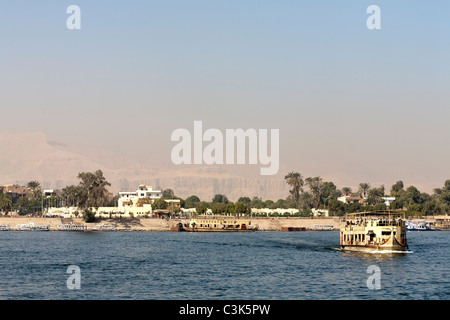 Luxor local ferry crossing from East Bank to West Bank with mountains in background, Luxor, Egypt, Africa Stock Photo