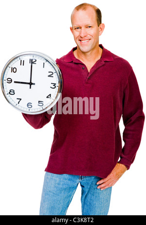 Confident man showing a clock and smiling isolated over white Stock Photo