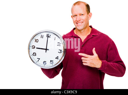 Caucasian man showing a clock and smiling isolated over white Stock Photo