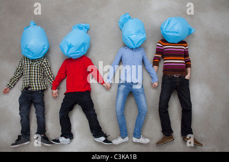 People covering their faces with plastic bags and showing ecology symbol Stock Photo