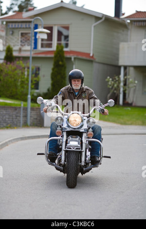 Senior man riding vintage motorbike Stock Photo