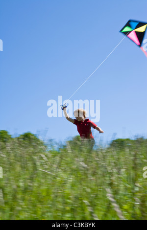 Boy running with kite Stock Photo