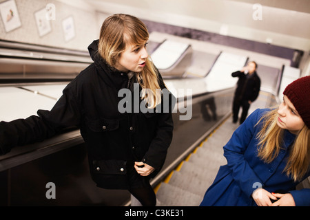 Two teenage girls (14-15) on escalator Stock Photo