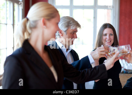 Three co-workers celebrating in office Stock Photo
