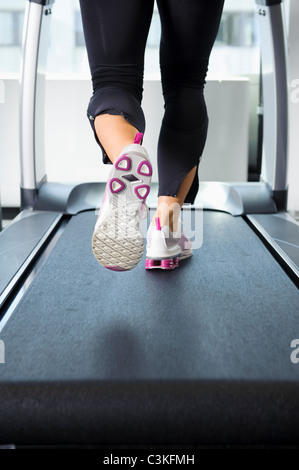 Low section of woman exercising on treadmill Stock Photo