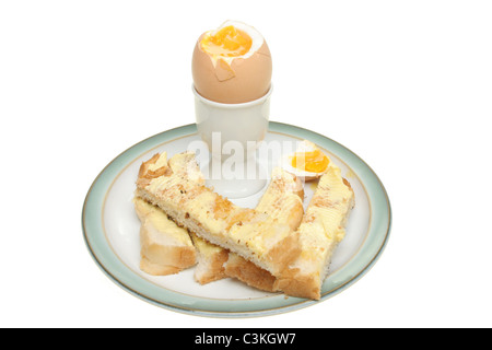 Soft boiled egg with buttered toast soldiers on a plate isolated against white Stock Photo