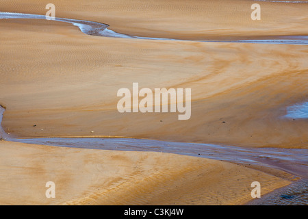 Rivulets and patterns in the sand at low tide on Seaton Sluice beach, Northumberland, UK Stock Photo