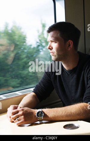 Man sitting in train Stock Photo