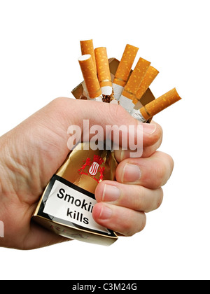 Hand Crushing a Packet of Cigarettes, Close Up, Cut Out. Stock Photo