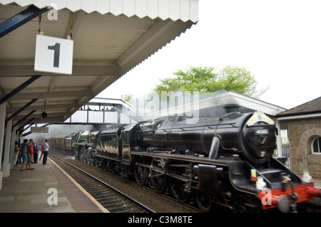 Double headed steam locomotives 'Black Five' 45305 and 'Brittania' 70013 'Oliver Cromwell' speed through St.Erth station. Stock Photo