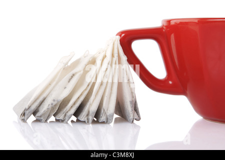 reflection of Red Ceramic cup with tea bags on white background Stock Photo