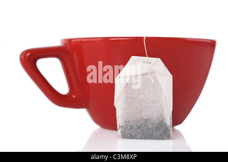 reflection of Red Ceramic cup with tea bag on white background Stock Photo