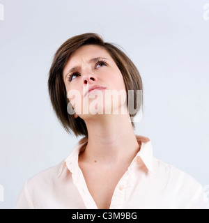 Young woman looking upwards - studio shot Stock Photo