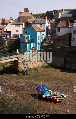 Staithes Beck, coble boat in the estuary of the small fishing village of Staithes, North Yorkshire, England, UK Stock Photo