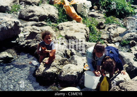 Chechaouen Morocco Children Helping Mothers Wash Clothes In River Stock Photo