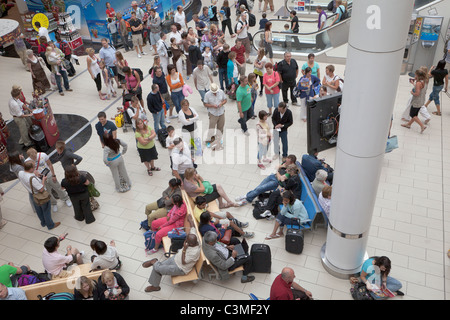 Passengers waiting for flight information at the departure lounge of the south terminal at Gatwick Airport, England Stock Photo