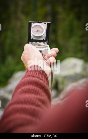 A mans hands holding a compass. Stock Photo