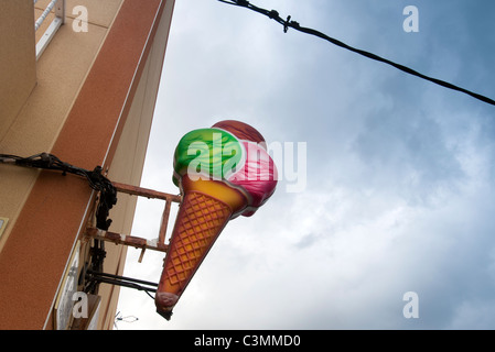 Ice cream sign on the wall outside cafe Stock Photo