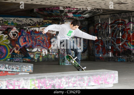 Young skateboarder enjoying himself at the South Bank, London. Stock Photo