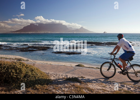 South Africa, Cape Town, Blouberg beach. Cyclist. Background: Table mountain.