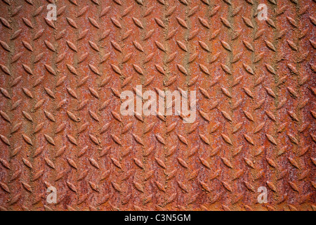 Photography shows a rusty metall background with diamond pattern. Stock Photo