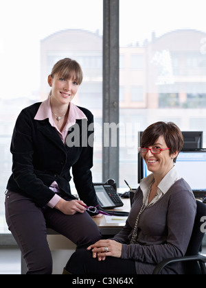 Two Women looking over some paper work in an Office Stock Photo