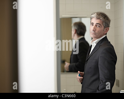 Business Man in bathroom Stock Photo