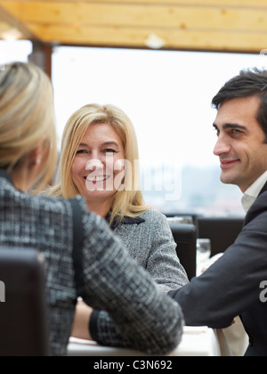 Two Women and one man in a buiness meeting Stock Photo